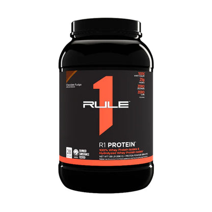 A container of Rule 1 R1 Protein Isolate, which is a black plastic bottle with orange and white text indicating 25g protein, 6g BCAAs, and being gluten-free.